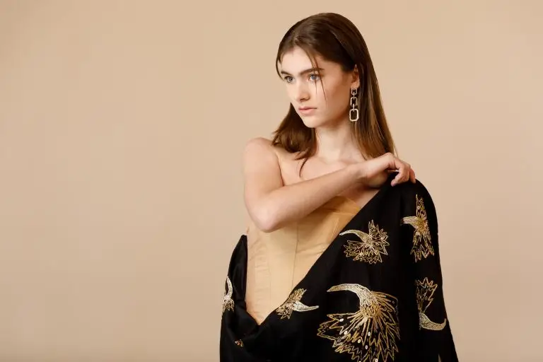 Model wearing beige couture corset with black silk train embroidered using Al Aire technique, from Saskia ter Welle’s collection “Cherish the Moment” at Thai Silk International Fashion Week 2022