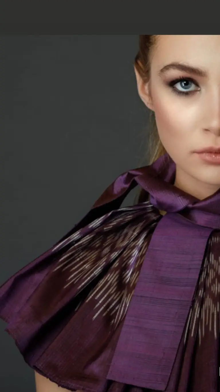 Close-up of pleated collar with patterned edge and detachable bow on purple Thai silk couture cocktail dress, by Saskia ter Welle