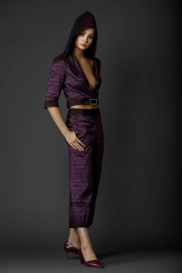 Purple Thai silk couture suit with woven pattern, featuring cropped wide-leg trousers and short jacket with hood, by Saskia ter Welle