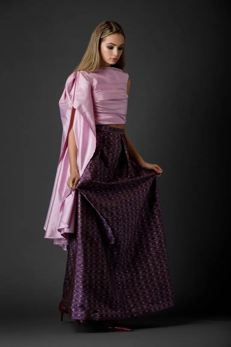 Full couture ensemble with patterned purple long skirt and sculpted light pink corset top, asymmetrical design with one bare arm and one voluminous sleeve, by Saskia ter Welle