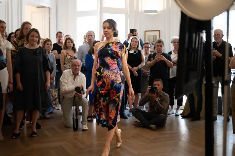Dancer wearing a multicolored asymmetrical silk couture dress with bold floral pattern and one bare shoulder, designed by Saskia ter Welle for the Pop Up exhibition in Paris