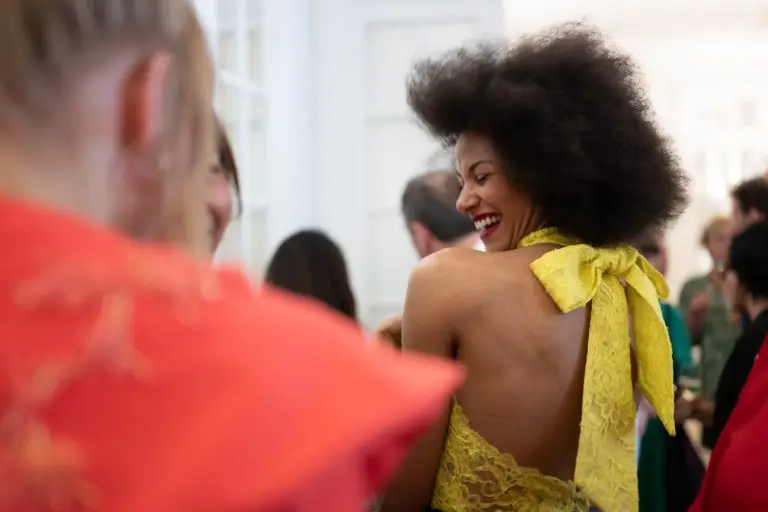 Back view of couture yellow lace halter top with large bow, designed by Saskia ter Welle and worn by a dancer at the Pop Up exhibition opening in Paris