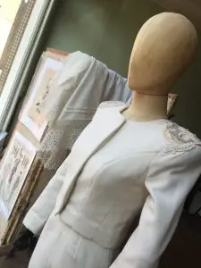 Off-white wool couture suit with embroidered epaulettes on a mannequin in the atelier of Saskia ter Welle in Doesburg