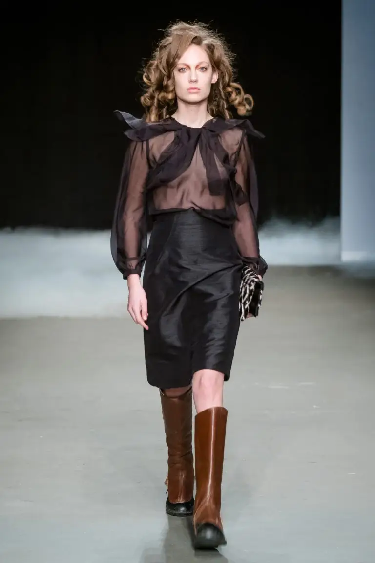 Black silk high-waisted skirt with flowing chiffon blouse featuring loose panels and long sleeves with small cuffs, couture by Saskia ter Welle