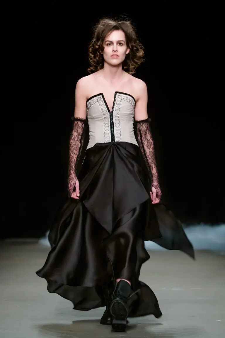 Couture evening gown at Amsterdam Fashion Week with sand-coloured bodice and black embroidery in Japanese pattern technique, asymmetrical silk organza skirt cut on the bias, by Saskia ter Welle