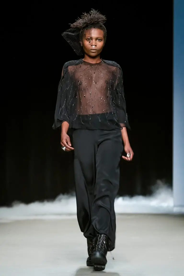 Couture evening ensemble with flowing black silk trousers and hand-embroidered sheer chiffon cape, embellished with jet-black beads and metallic threads, by Saskia ter Welle