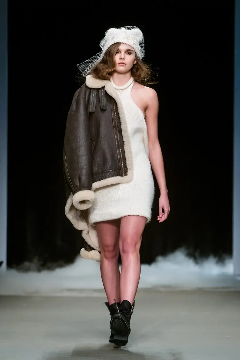 Off-white short merino wool knitted dress with halter neckline, open back tied in a bow, styled with hand-embroidered merino beanie using broderie d’art with beads, sequins and ribbon, couture by Saskia ter Welle